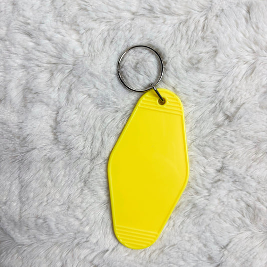 Yellow keychain on a gray textured surface