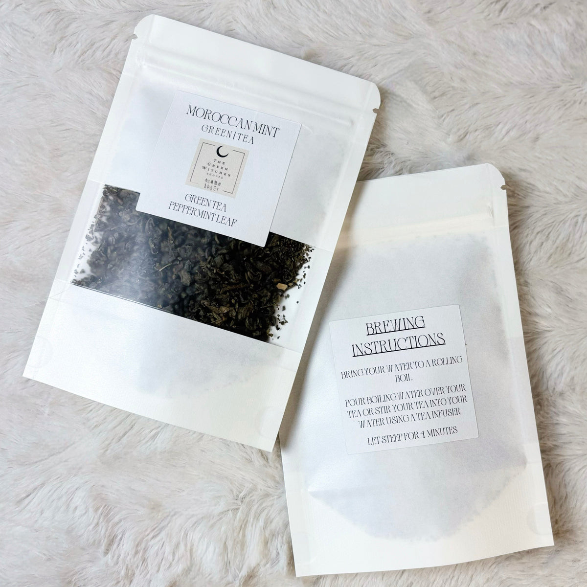 Tea bags with labels on a light gray surface