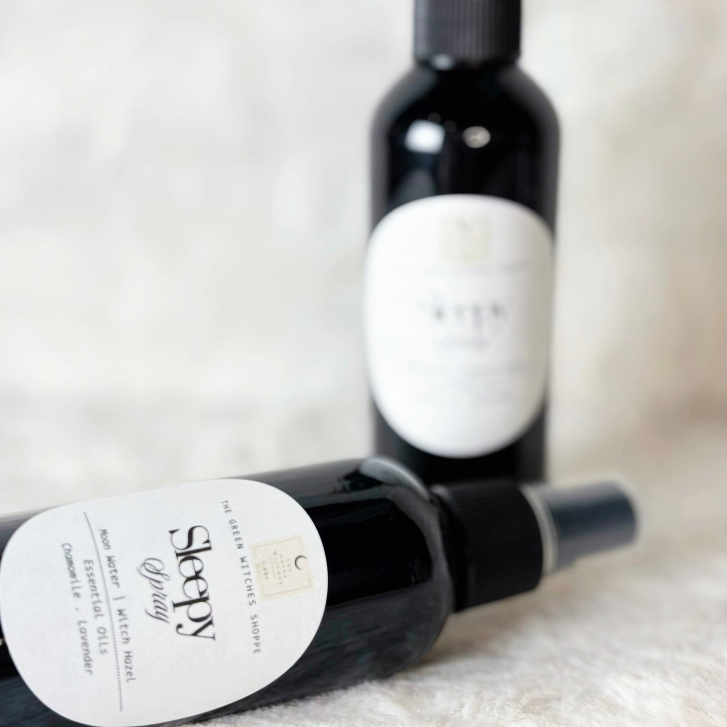 Two bottles of Sleepy Lizard craft beer on a textured surface