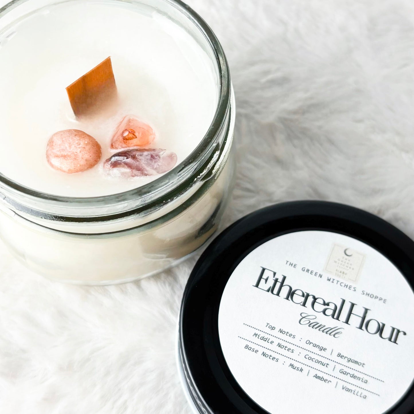 Candle in a glass jar with a black lid labeled 'Ethereal Hour' on a white background