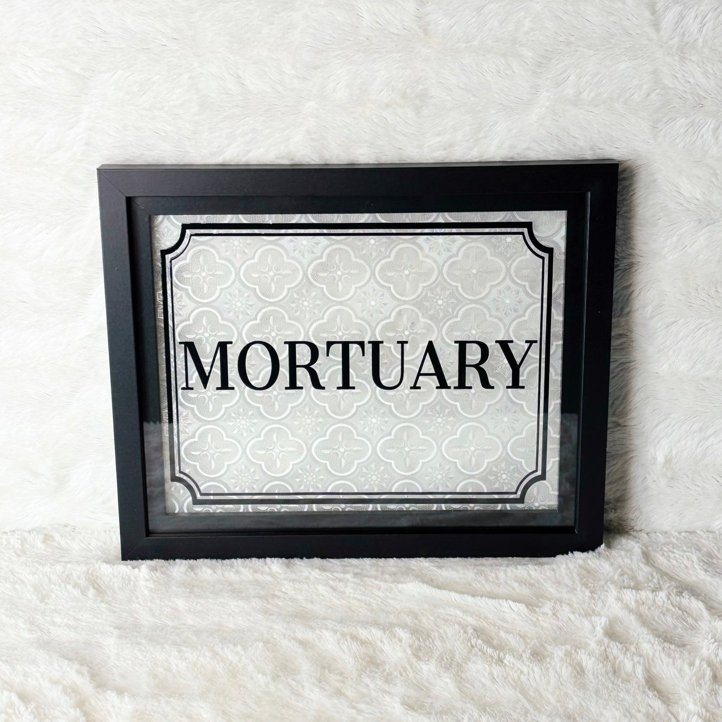 Framed sign with 'Mortuary' text on a white background