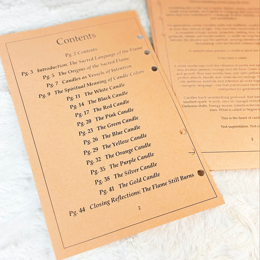 A printed booklet or instruction sheet titled 'Contents' with a list of candle chapters, placed on a white textured fabric next to another folded page.