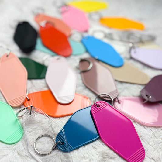 Color swatches and keychains in various colors on a textured surface