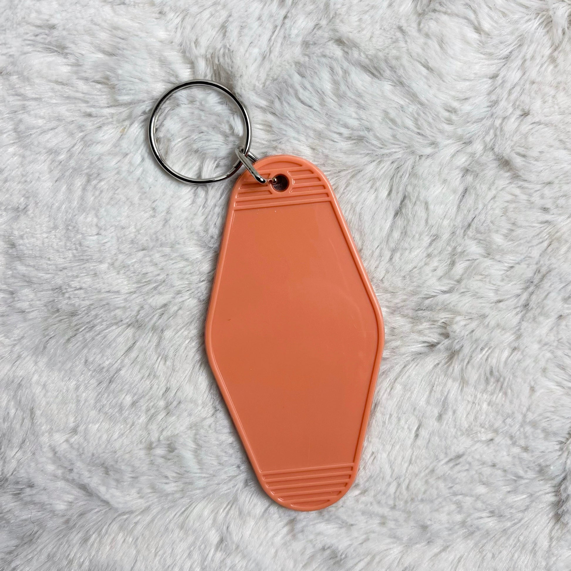 Brown keychain on a gray fluffy surface