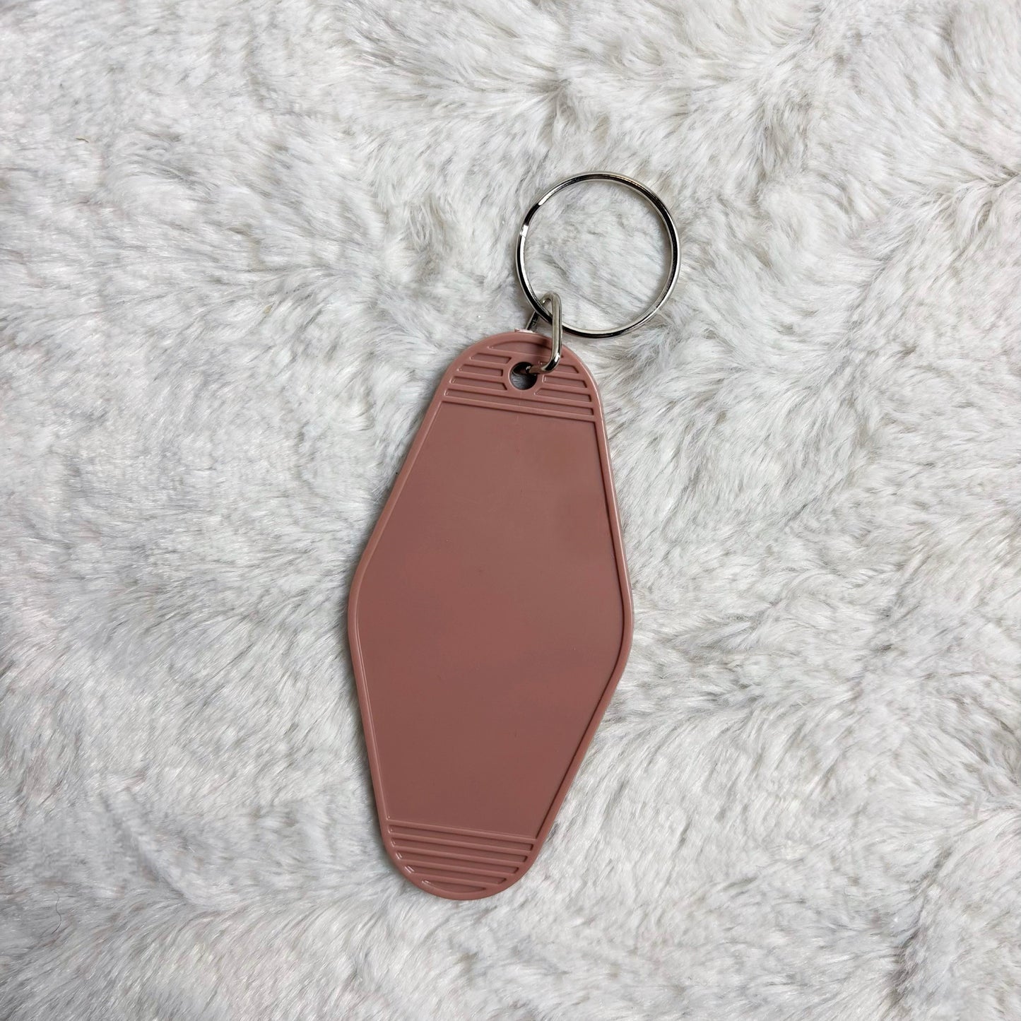 Brown keychain on a fluffy white surface