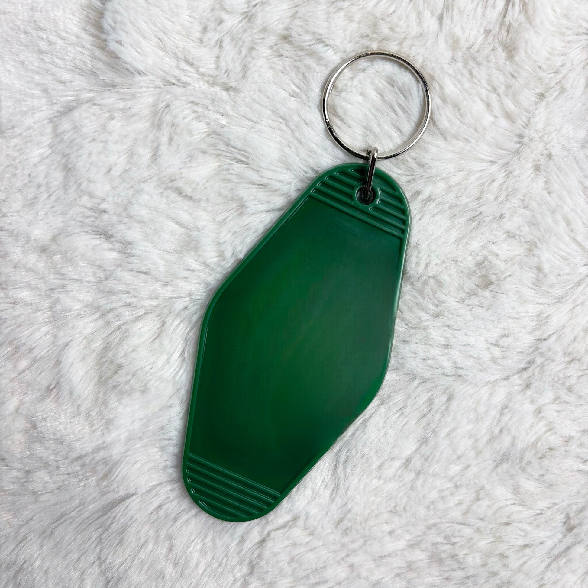 Green keychain on a white fluffy surface