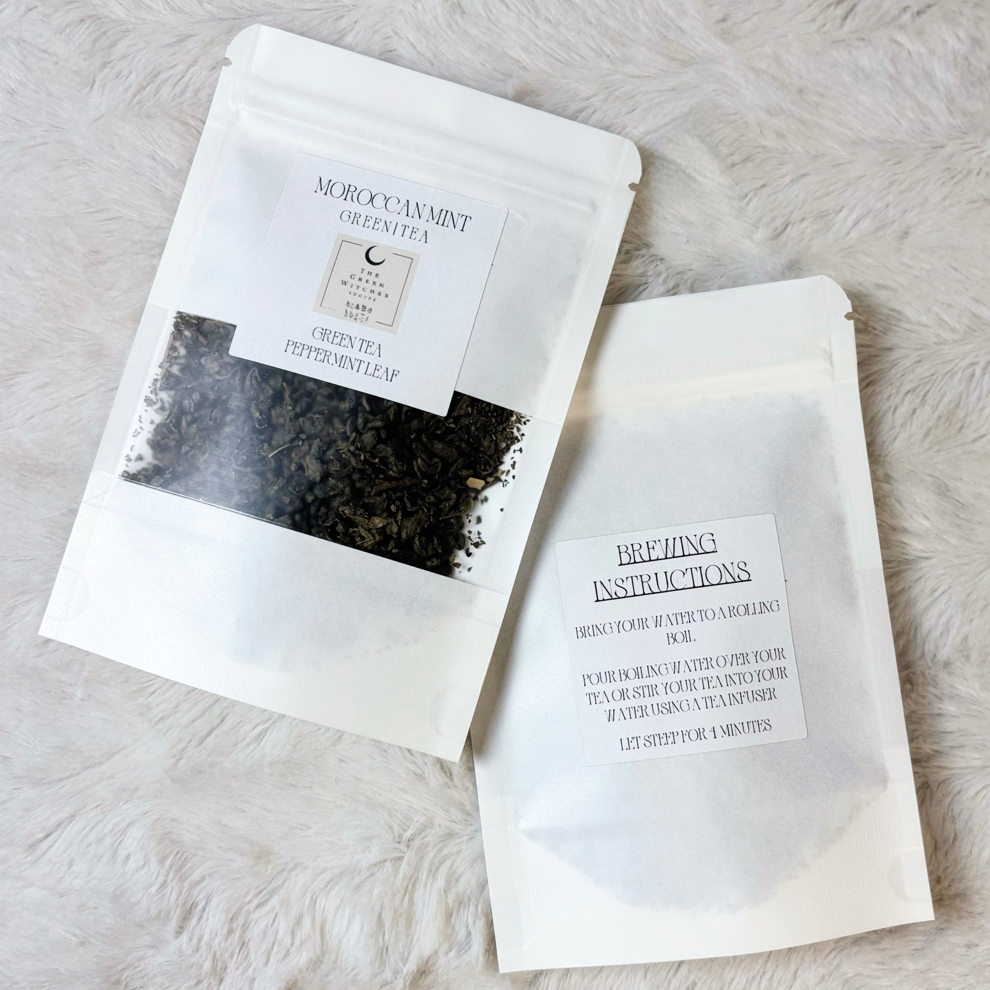 Tea bags with labels on a light gray surface