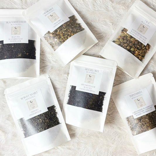 Tea bags with visible tea leaves on a soft, light-colored surface