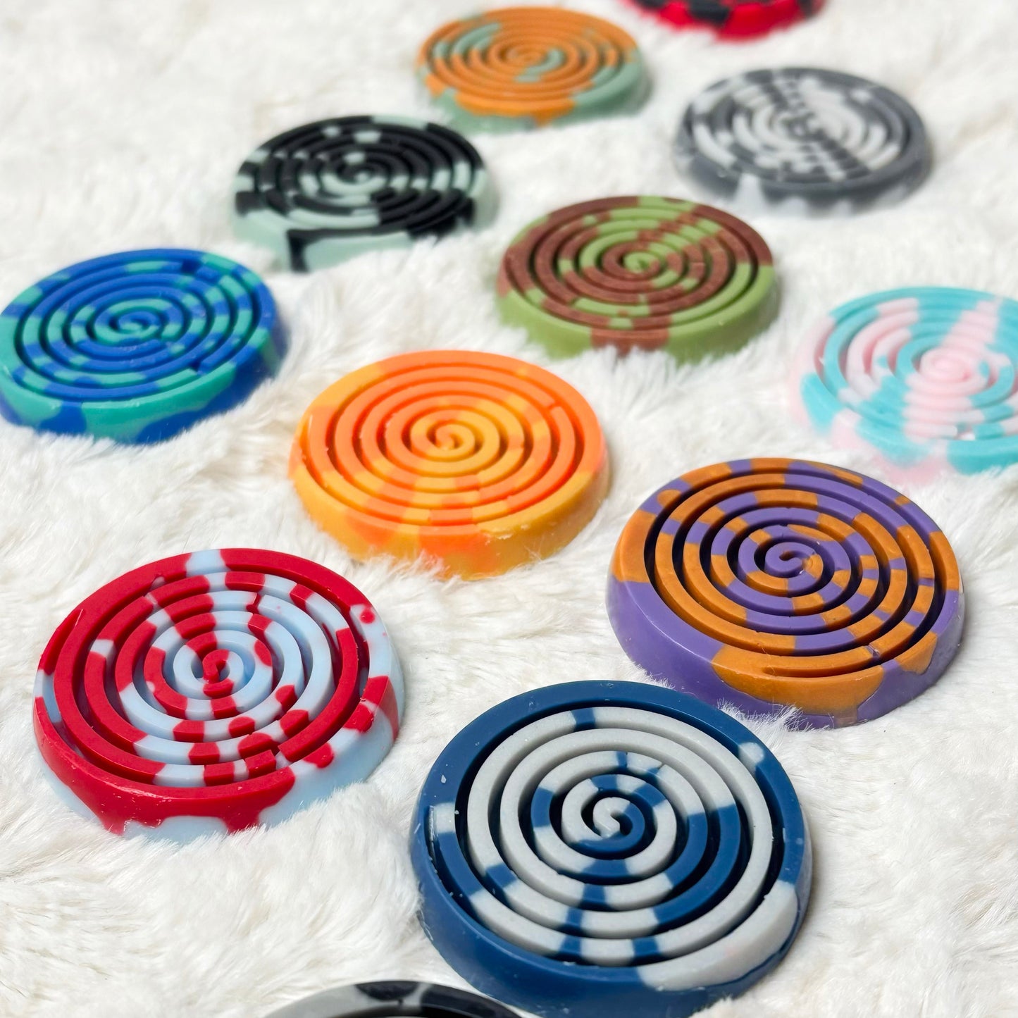 Colorful spiral-patterned items on a textured white surface