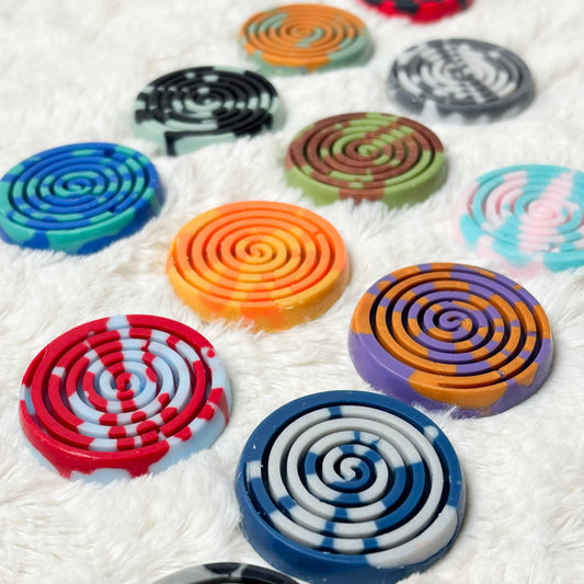 Colorful spiral-patterned items on a textured white surface