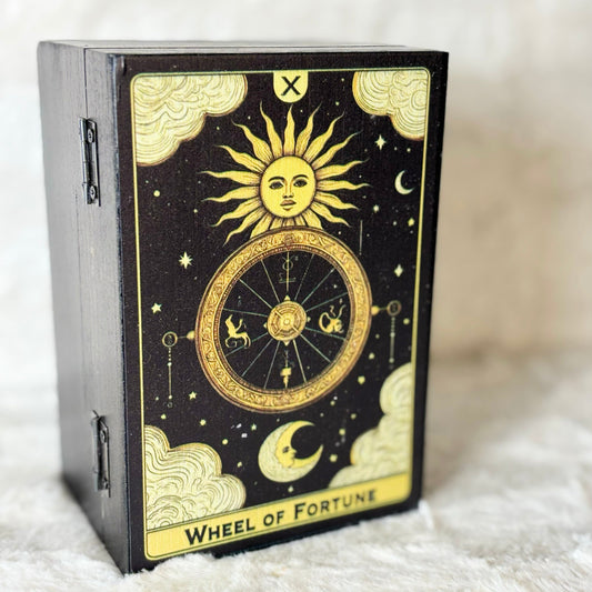 Decorative box with 'Wheel of Fortune' design on a soft white surface