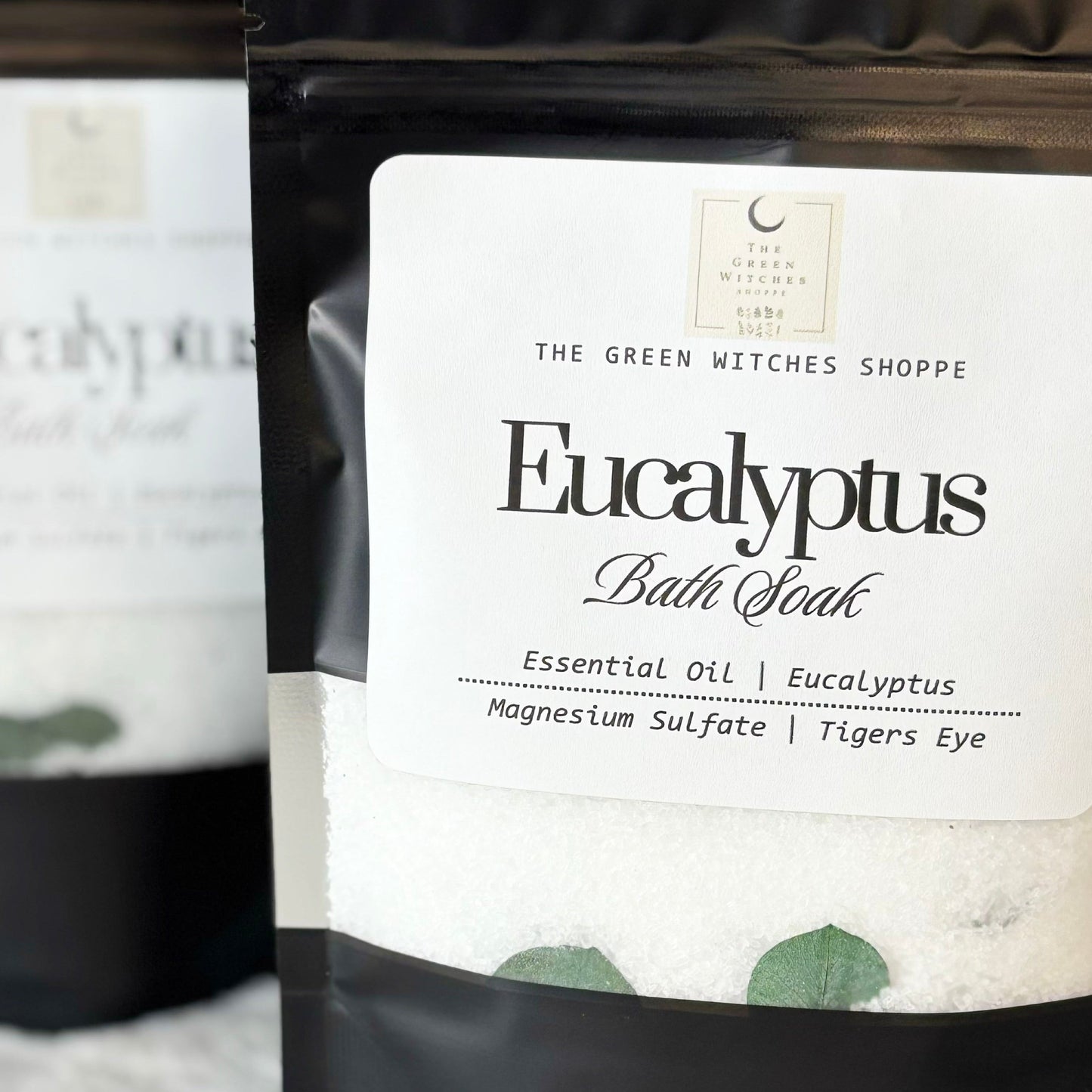 bags of eucalyptus bath soak on a white surface.