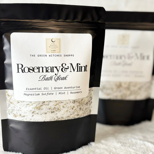Rosemary & Mint bath soak packaging with visible brand label on a textured surface.