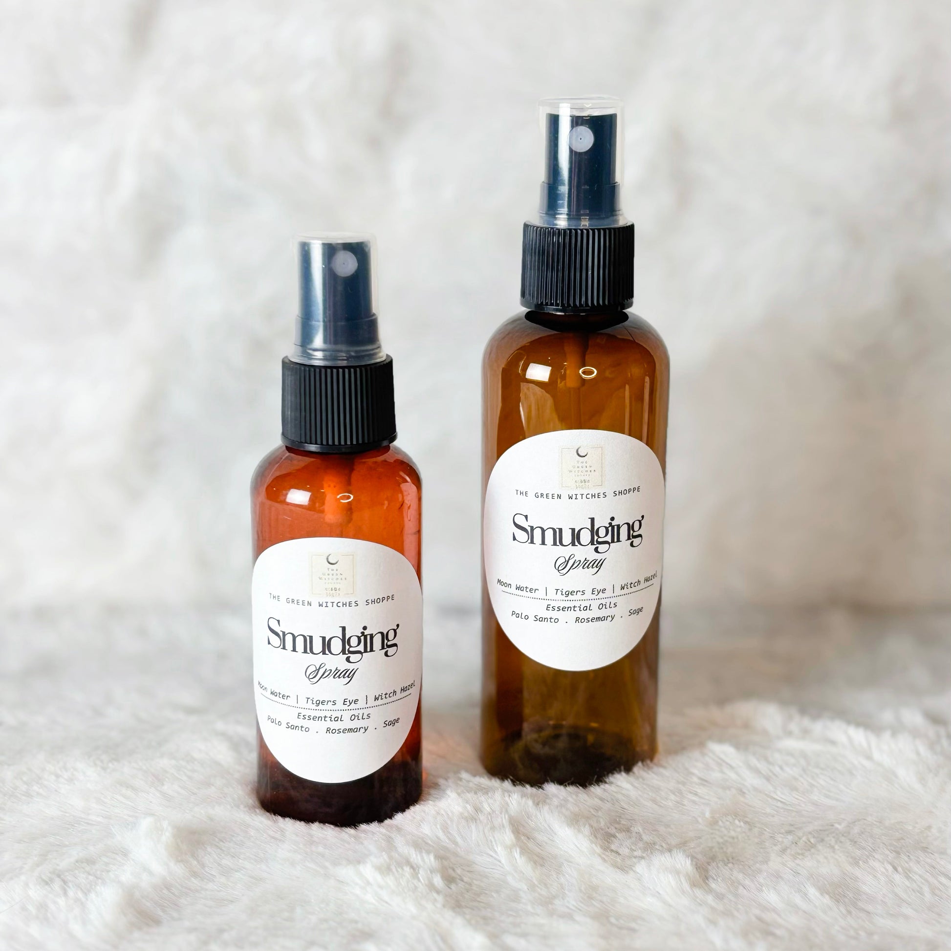 Two brown spray bottles with labels on a white textured surface