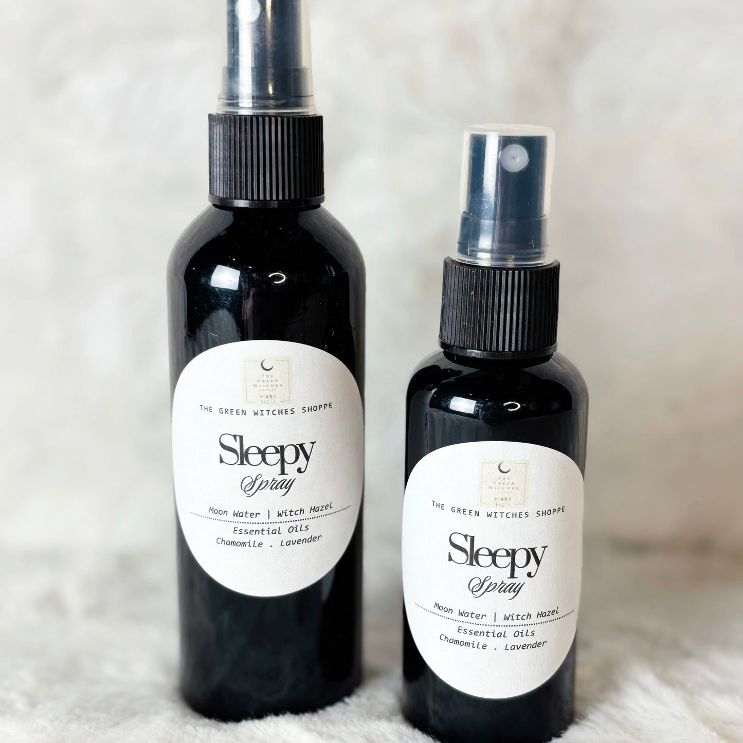 Two bottles of 'Sleepy Spray' on a textured white surface