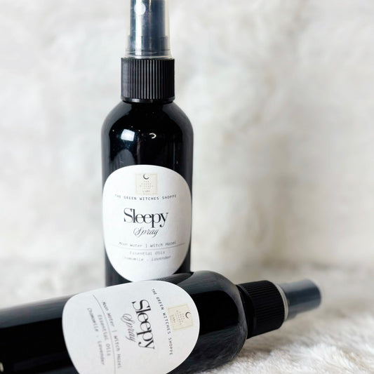 Two bottles of 'Sleepy' spray on a white surface