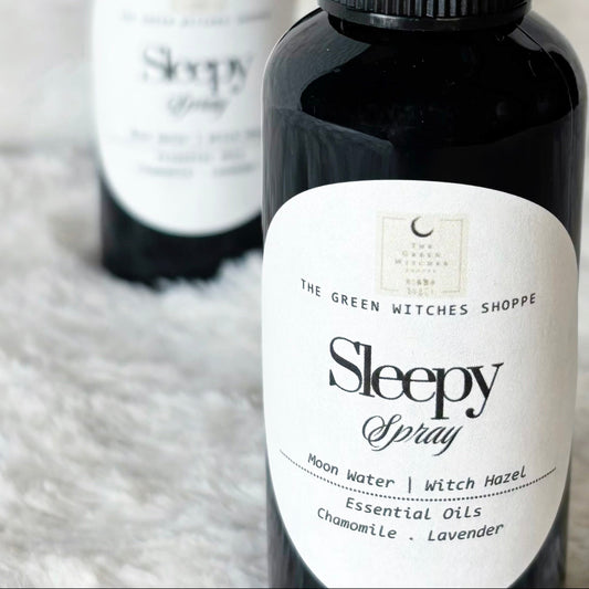 Two bottles of 'Sleepy Spray' on a fluffy white surface