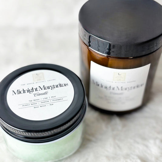 Two candles labeled 'Midnight Margaritas' on a white surface