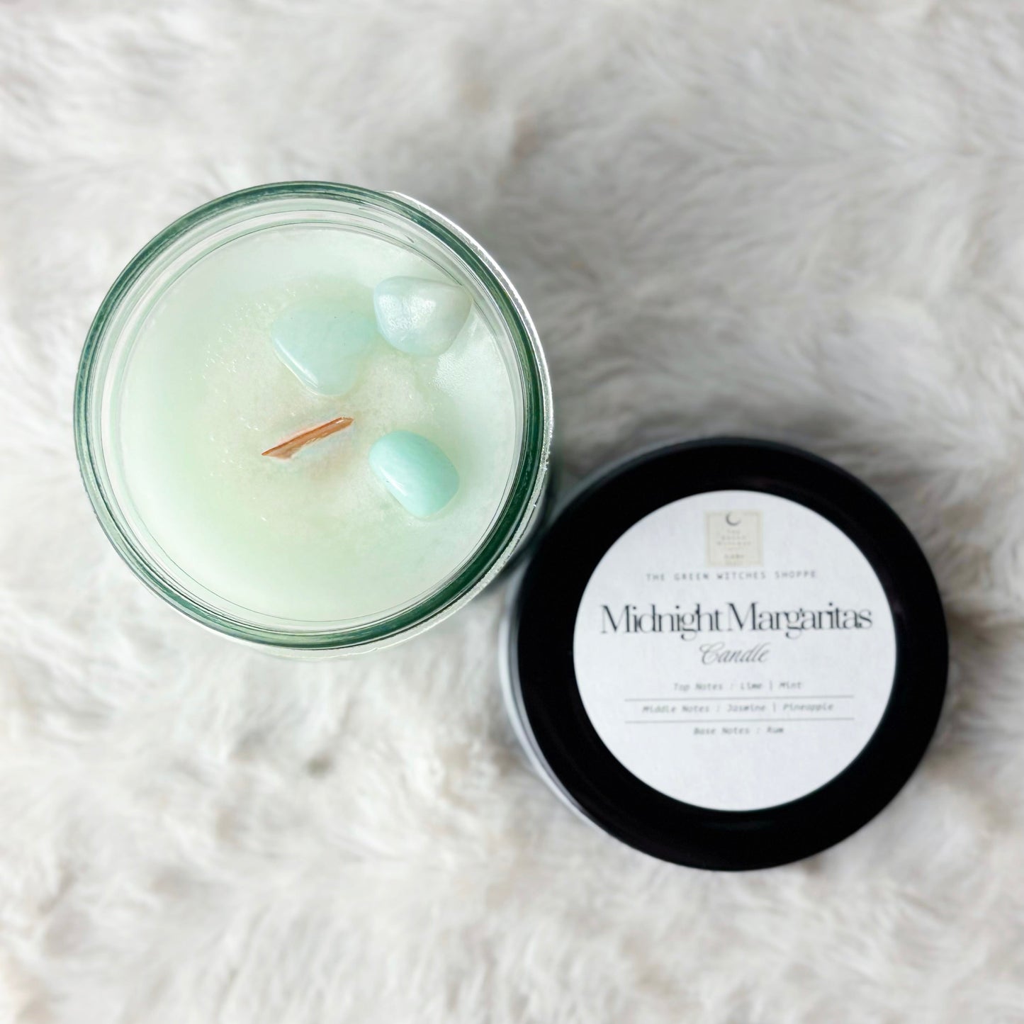 Candle with a label on a white textured surface