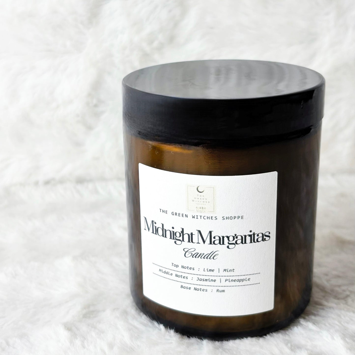 Candle labeled 'Midnight Margaritas' on a white textured background