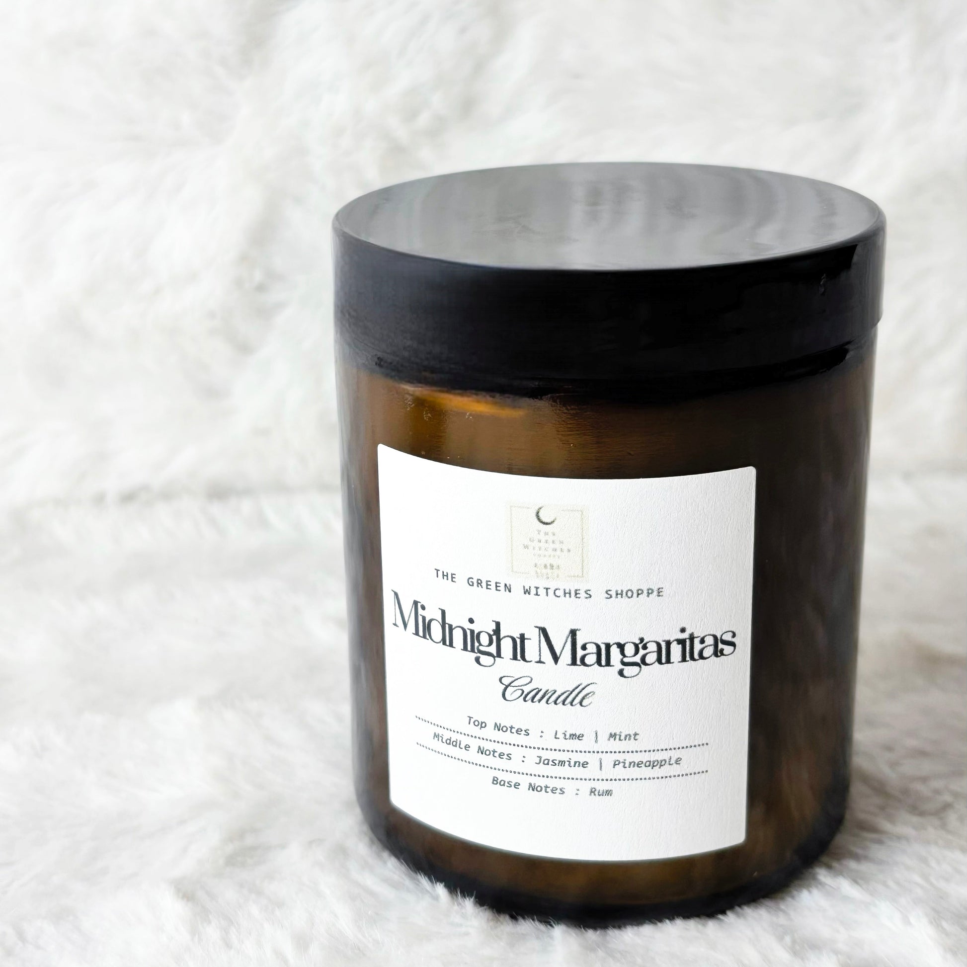 Candle labeled 'Midnight Margaritas' on a white textured background