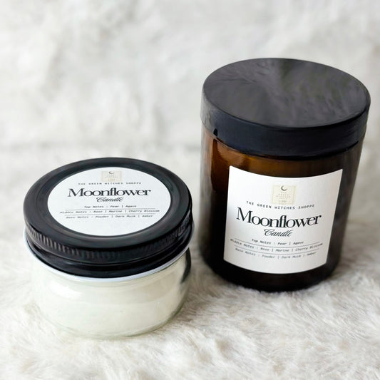 Two Moonflower candles on a white textured surface
