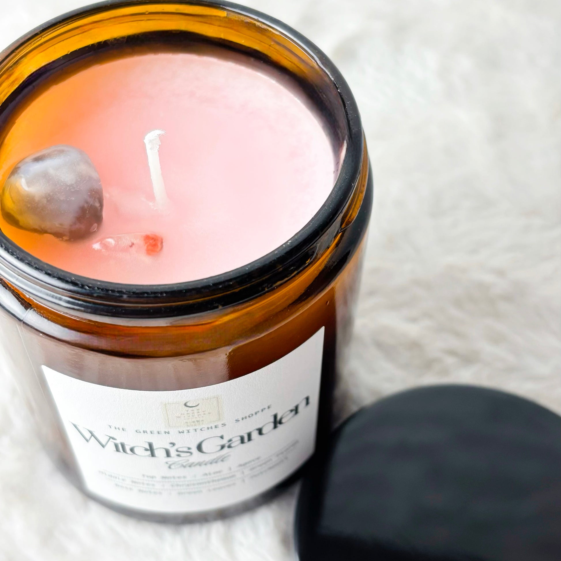 Candle in an amber jar with a label on a white background