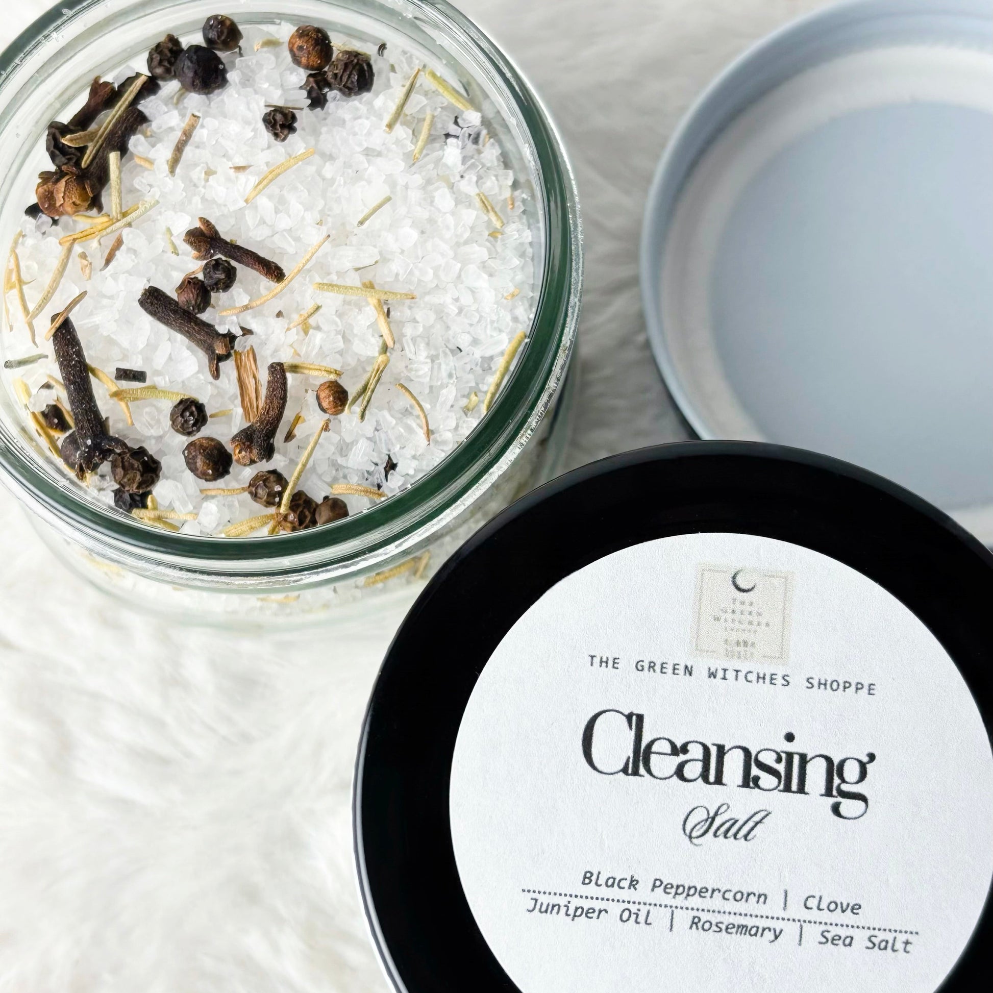 Cleansing salt with black peppercorns and clove on a white background