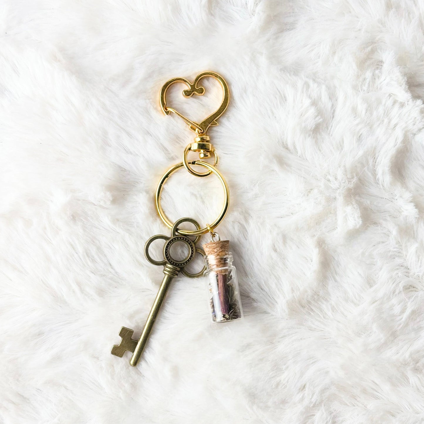 Keychain with vintage keys and a heart-shaped clasp on a white textured background