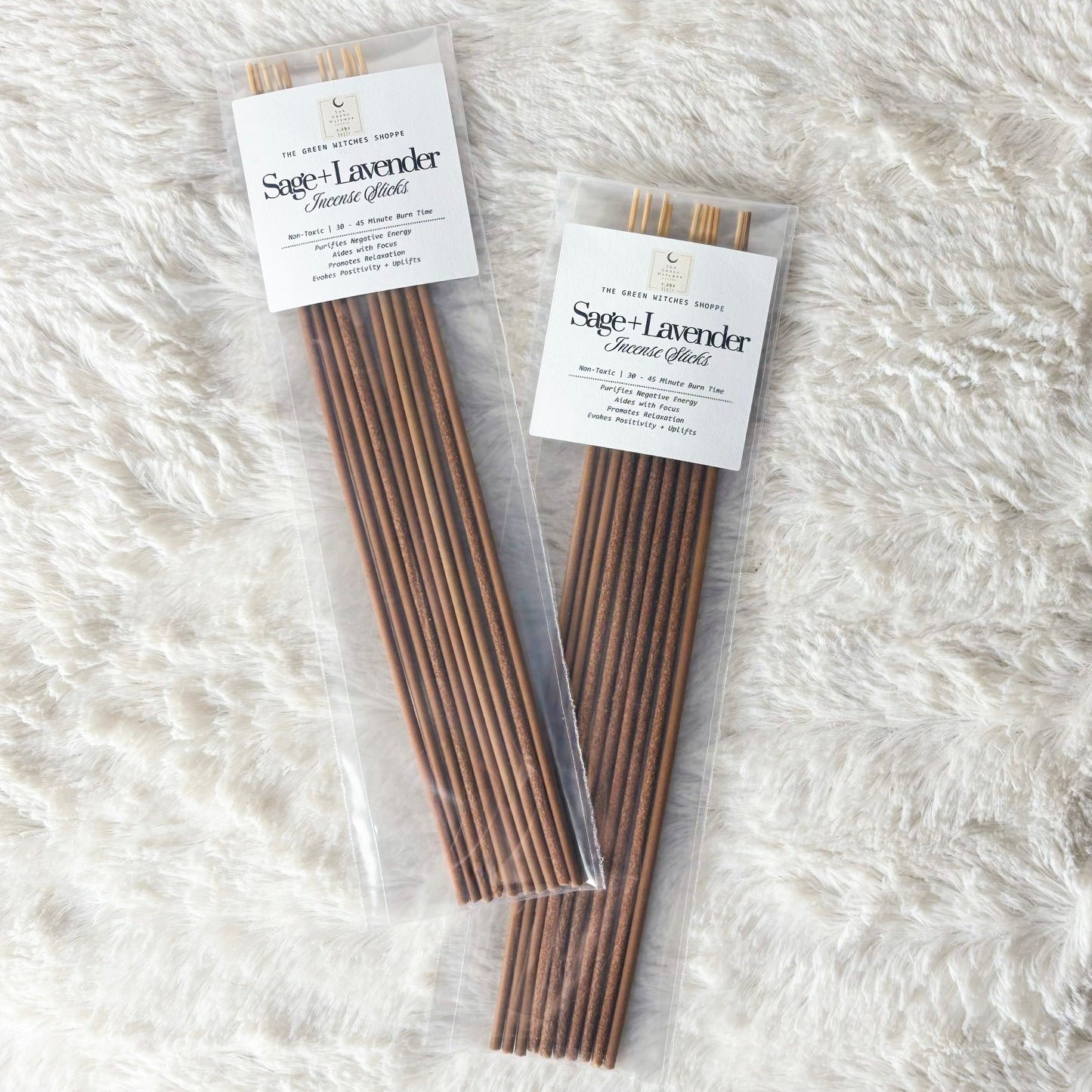Two packages of Sage Lavender Incense Sticks on a white fluffy surface