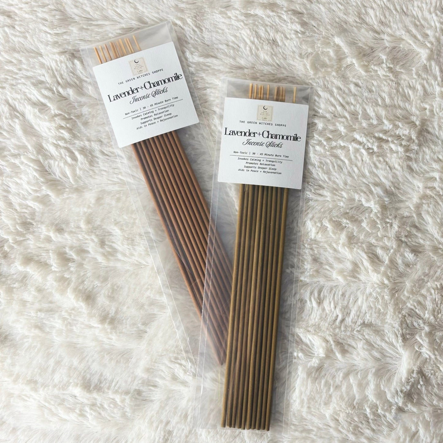 Two packages of Lavender Chamomile incense sticks on a white textured surface