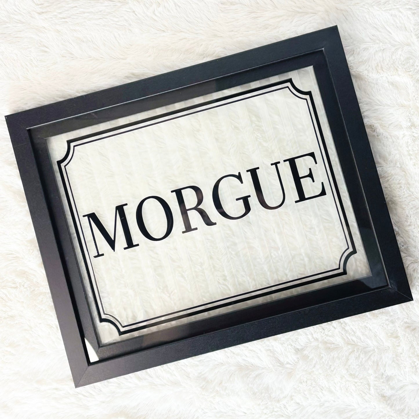 Framed sign with 'Morgue' text on a white background