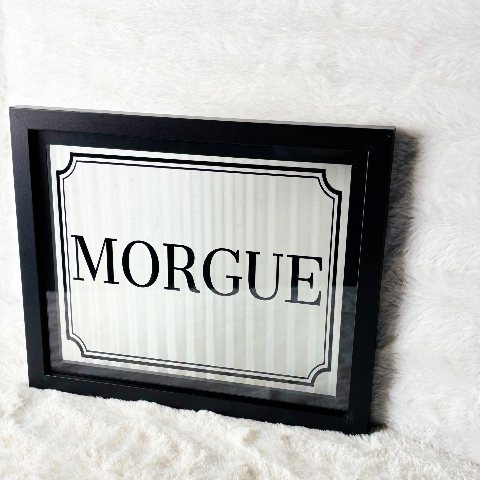 Framed sign with 'Morgue' text on a white background
