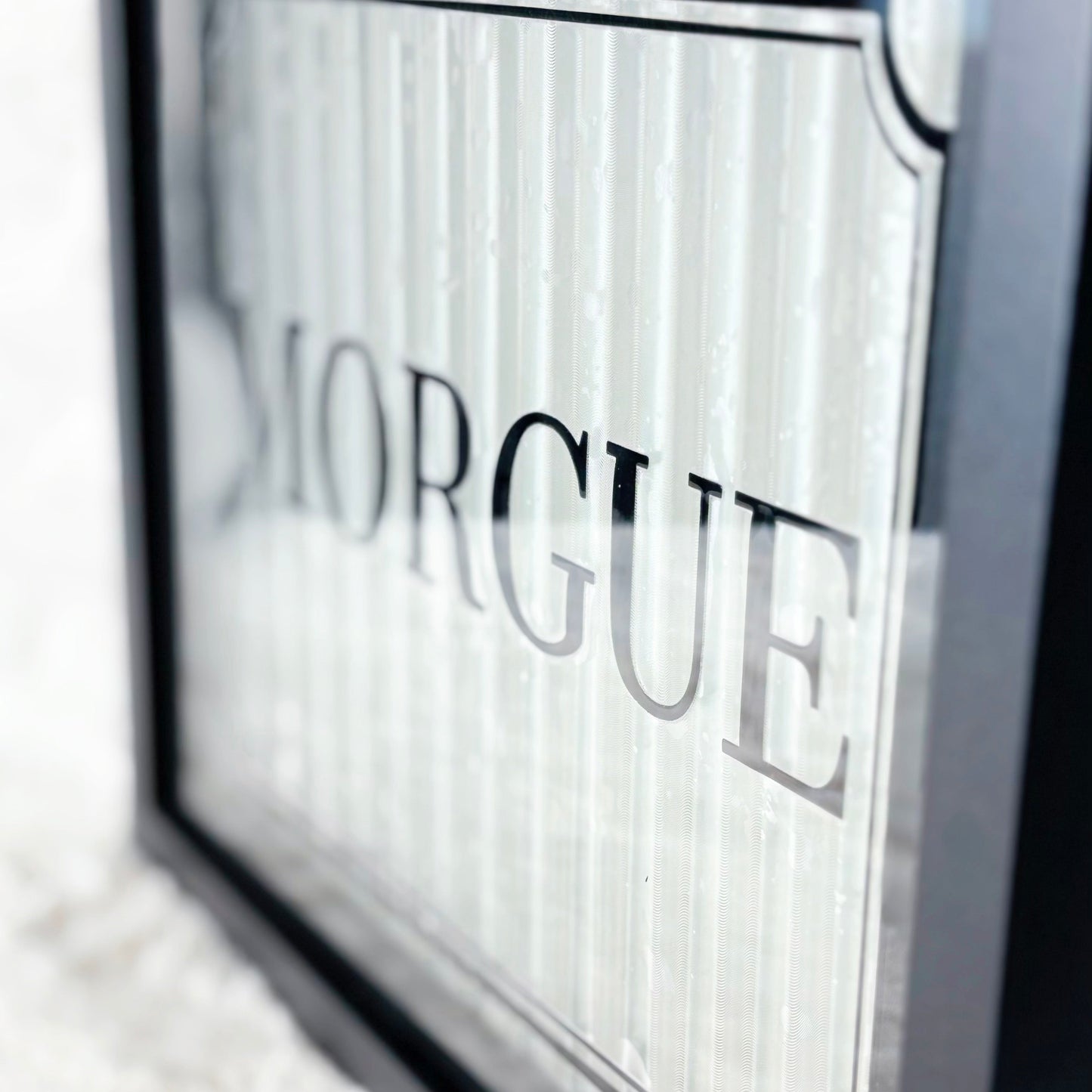 Framed sign with 'Morgue' text on a white background