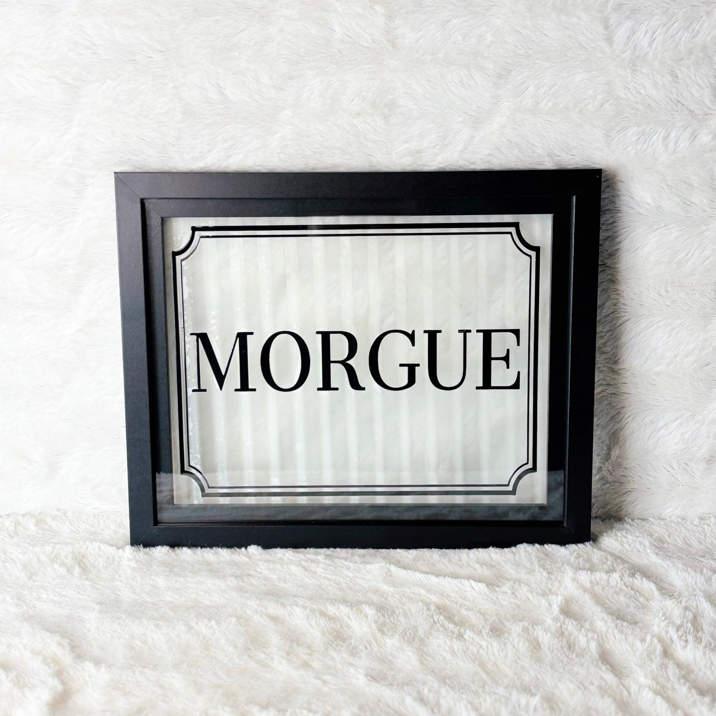 Framed sign with 'Morgue' text on a white background