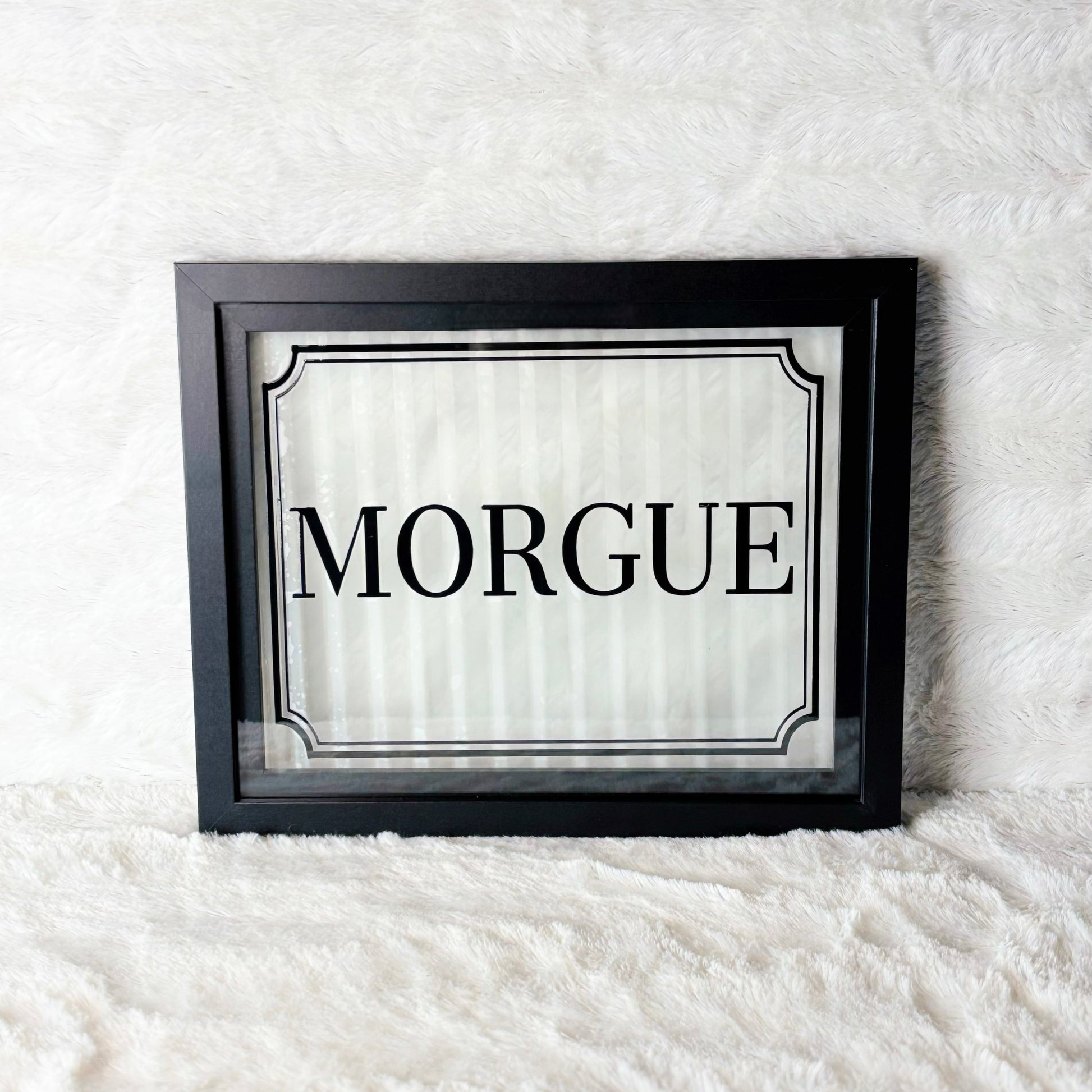 Framed sign with 'Morgue' text on a white background