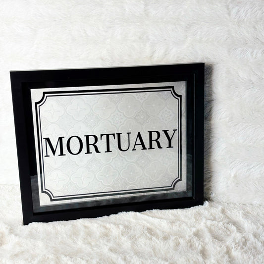 Framed sign with 'Mortuary' text on a white background