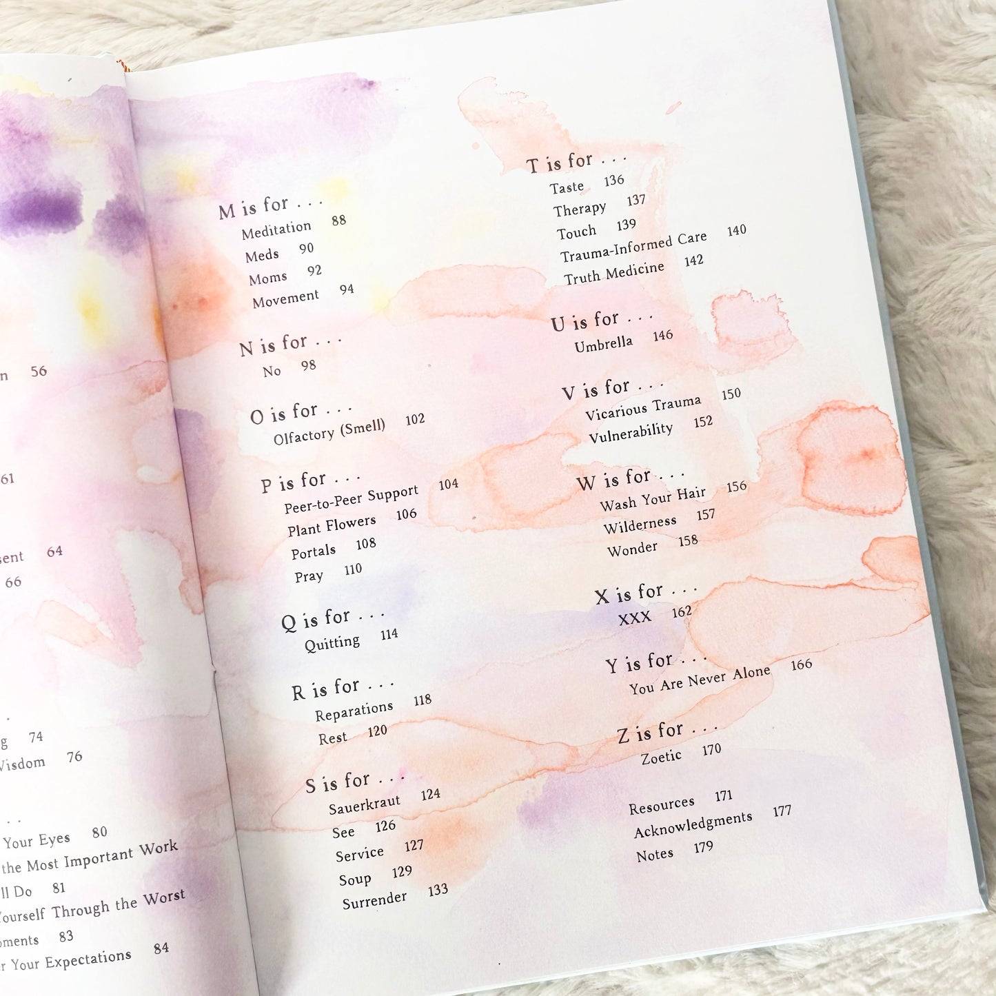 Open book with watercolor pages on a textured surface