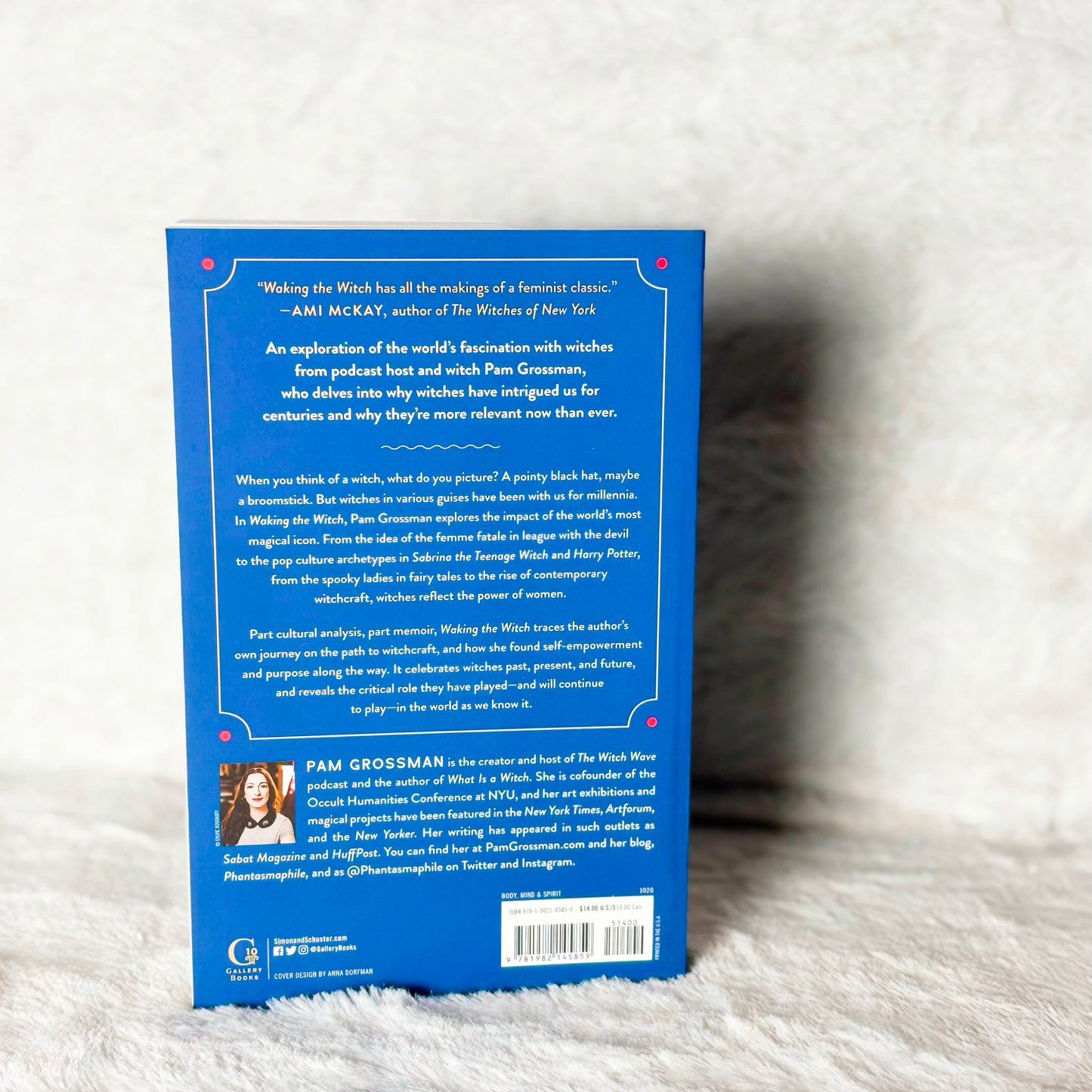 Back cover of a book with text and a photo on a white textured surface