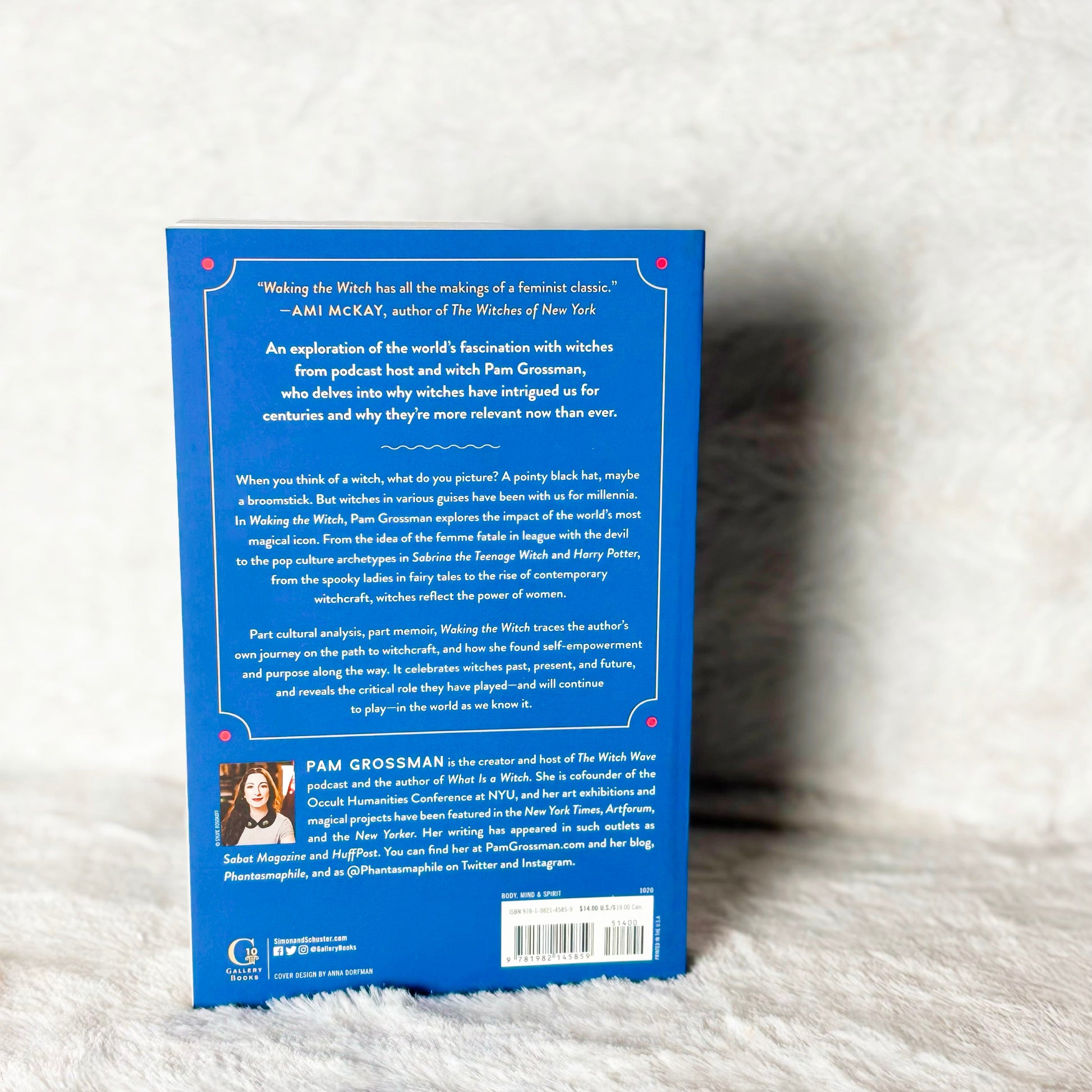 Back cover of a book with text and a photo on a white textured surface
