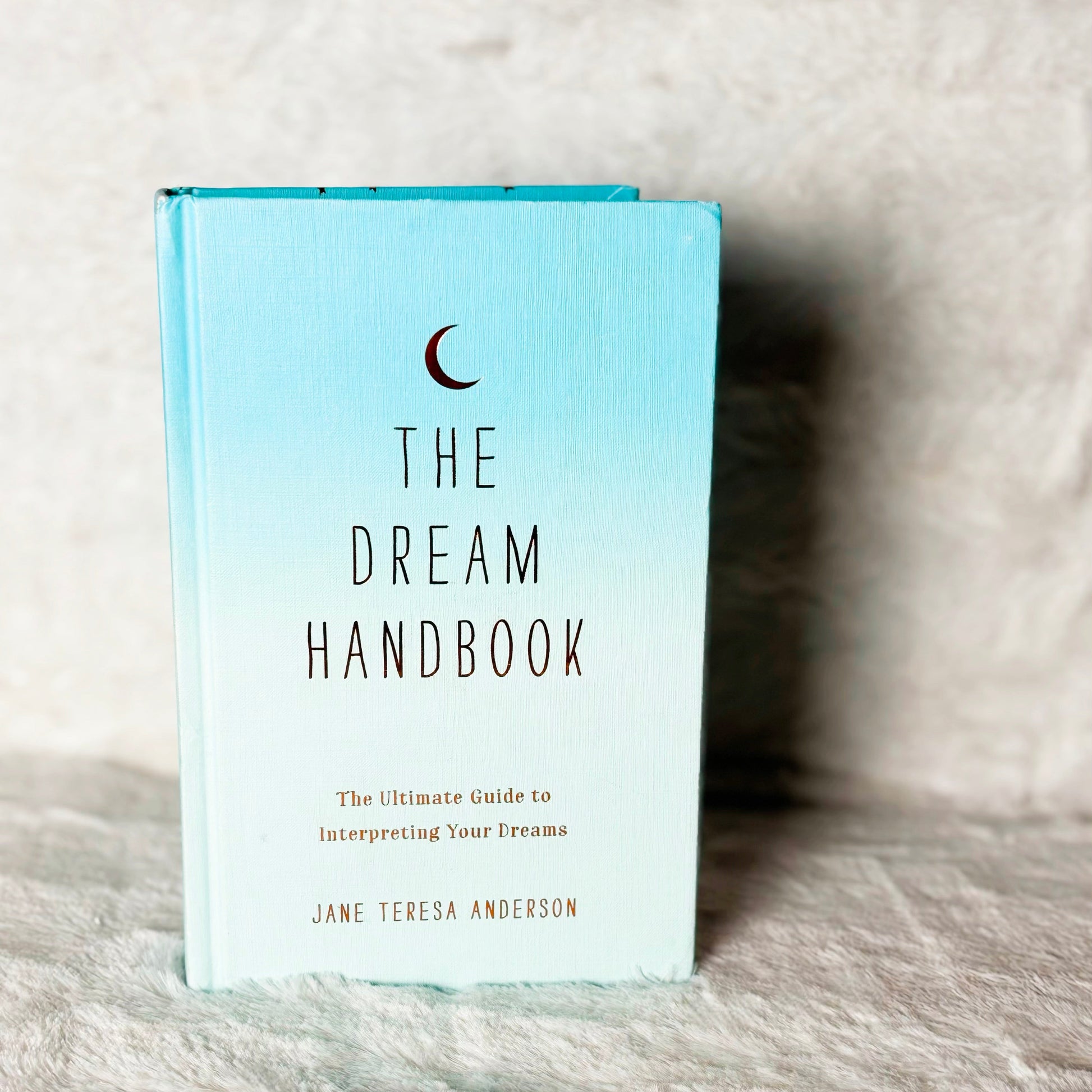 Book titled 'The Dream Handbook' on a textured surface