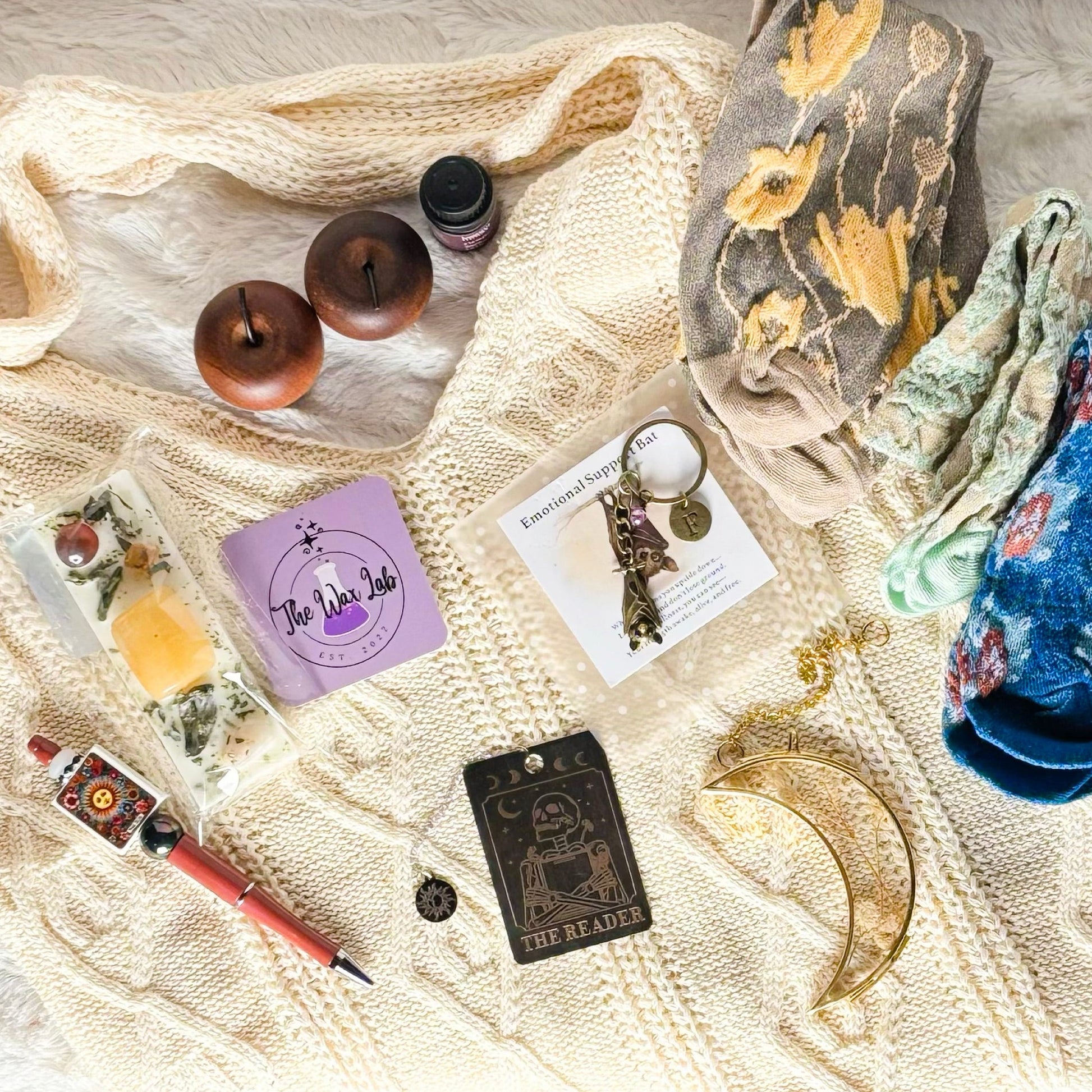 Collection of small items on a textured surface with a box in the foreground.