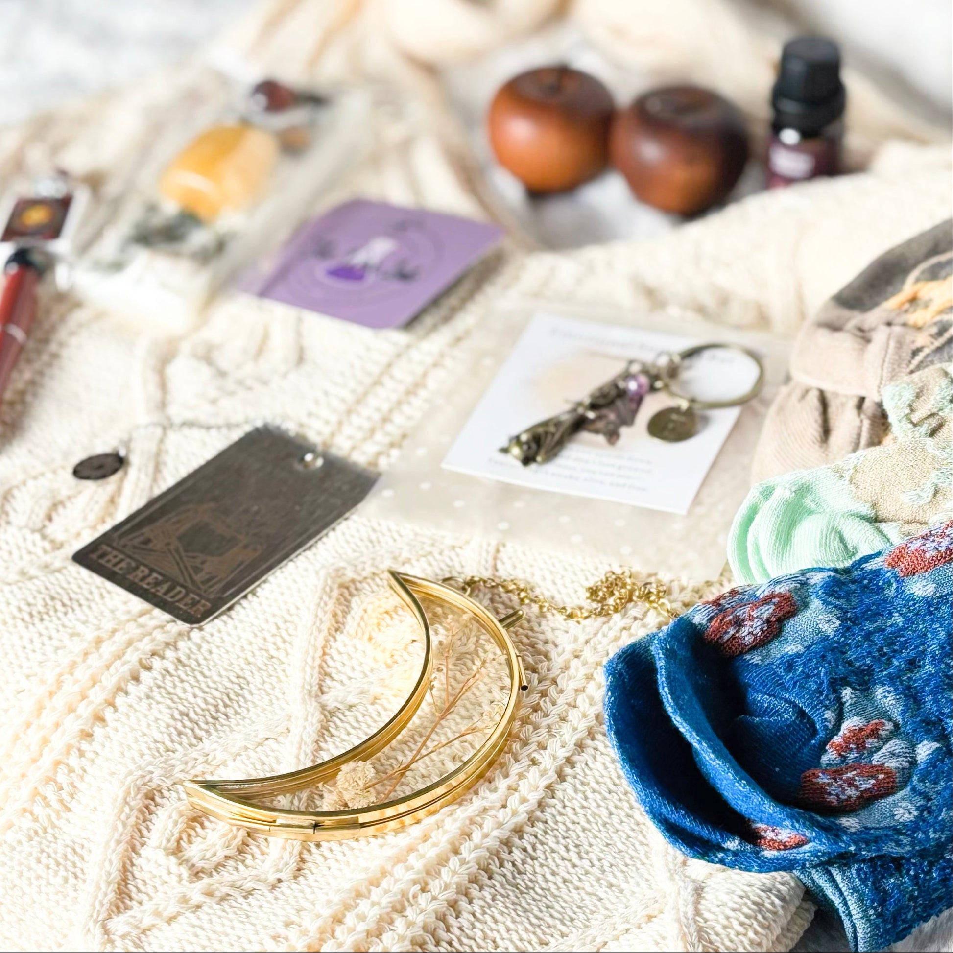 Collection of small items on a textured surface with a focus on a blue fabric item.