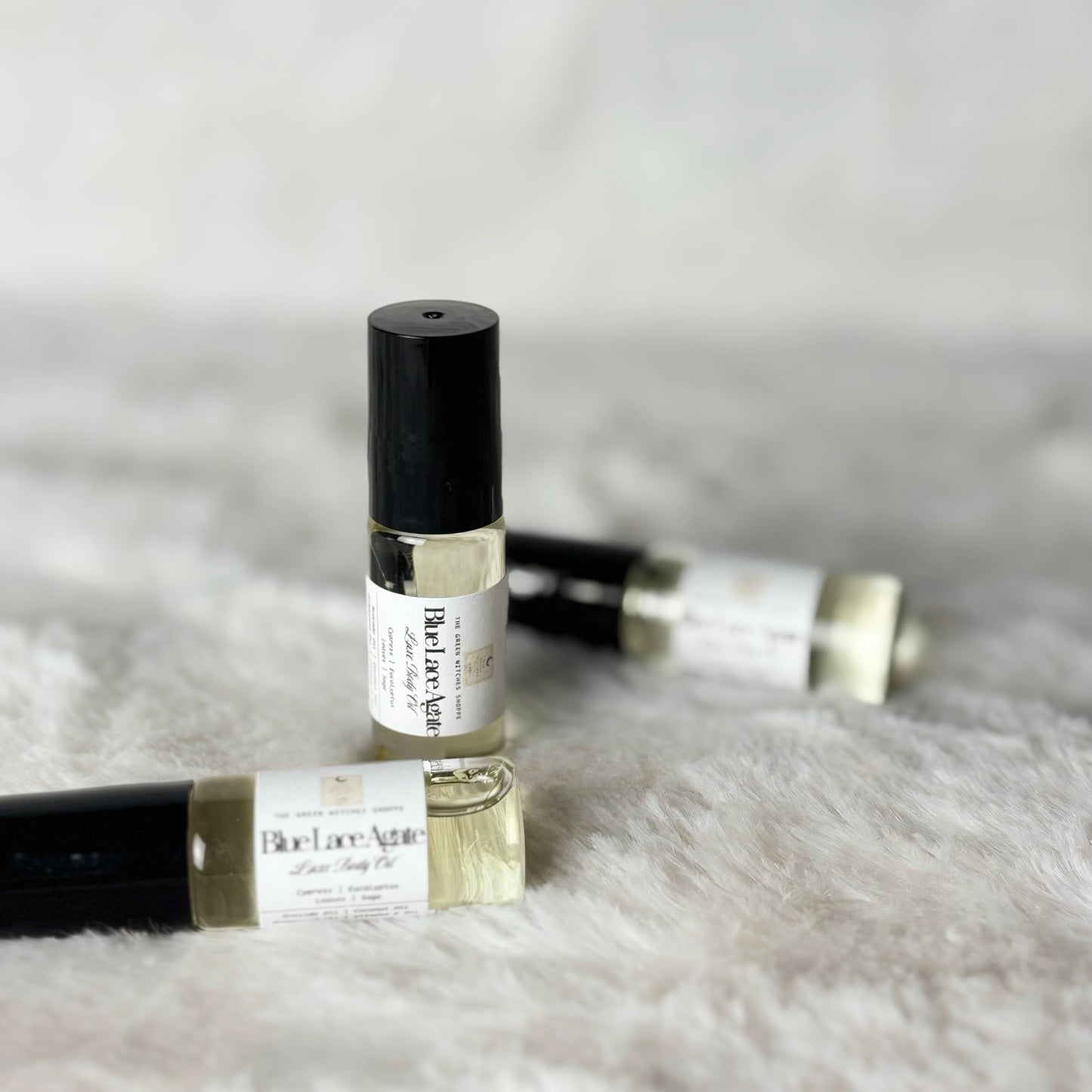 Roll-on perfume bottles on a fluffy white surface