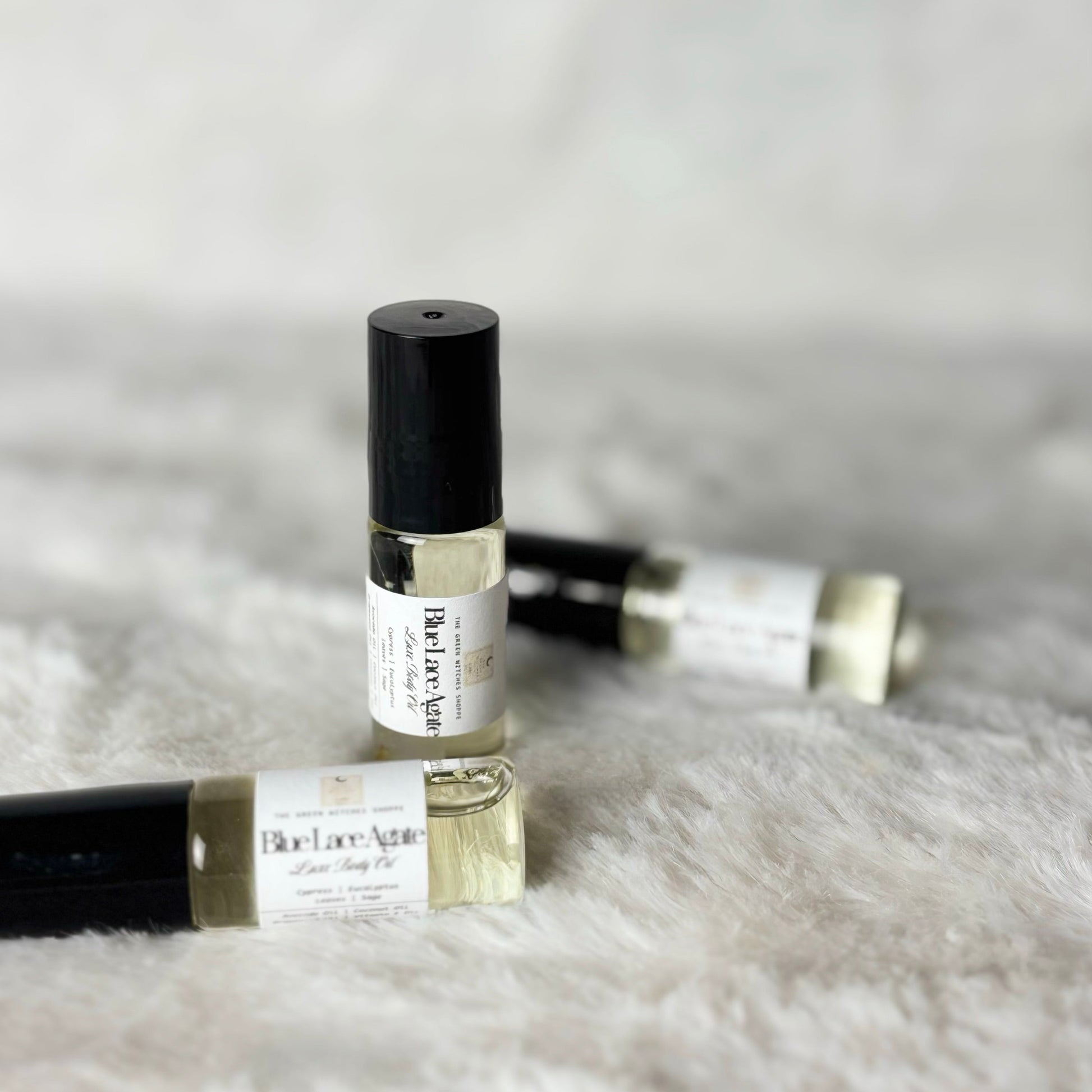 Roll-on perfume bottles on a fluffy white surface