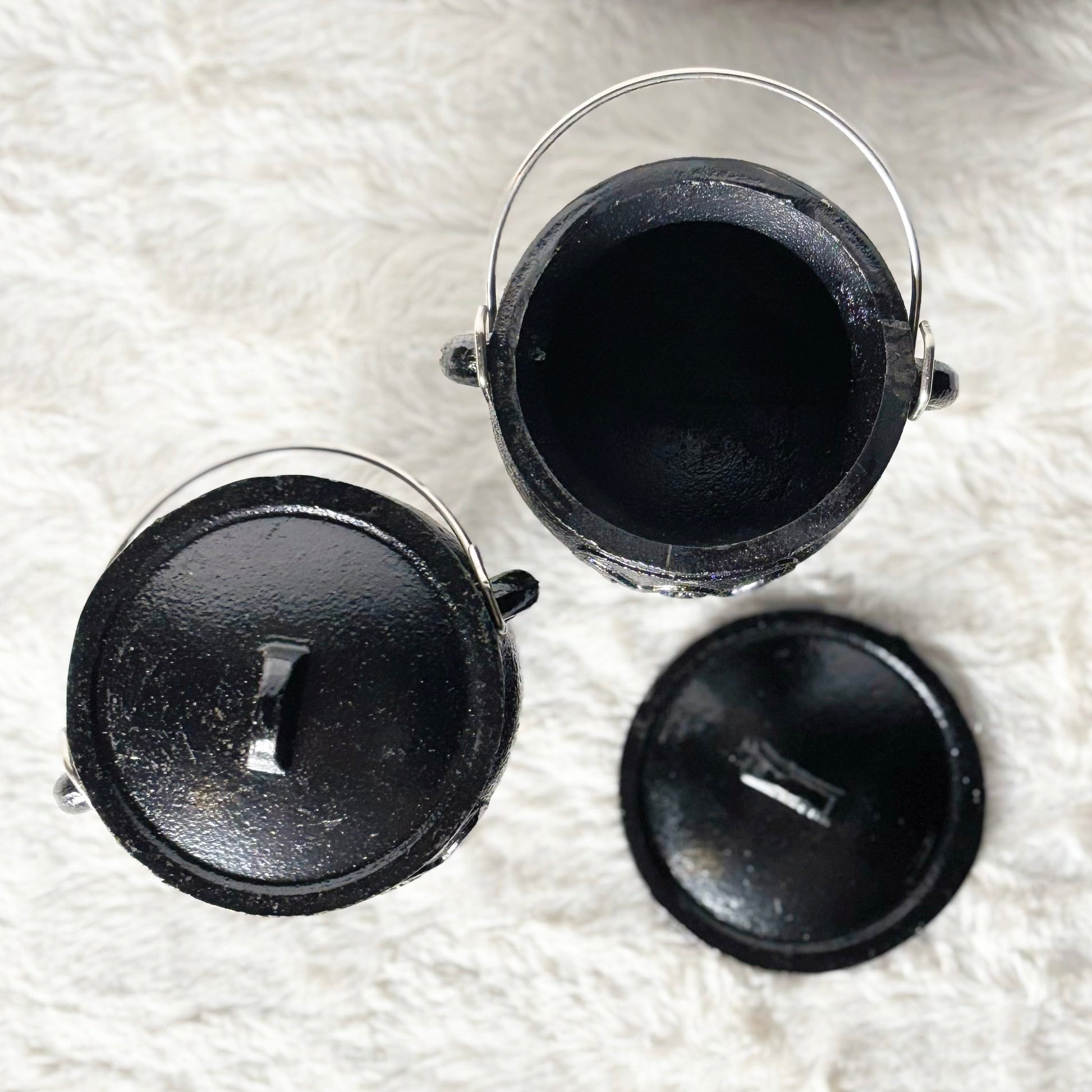 Black round objects on a white textured surface