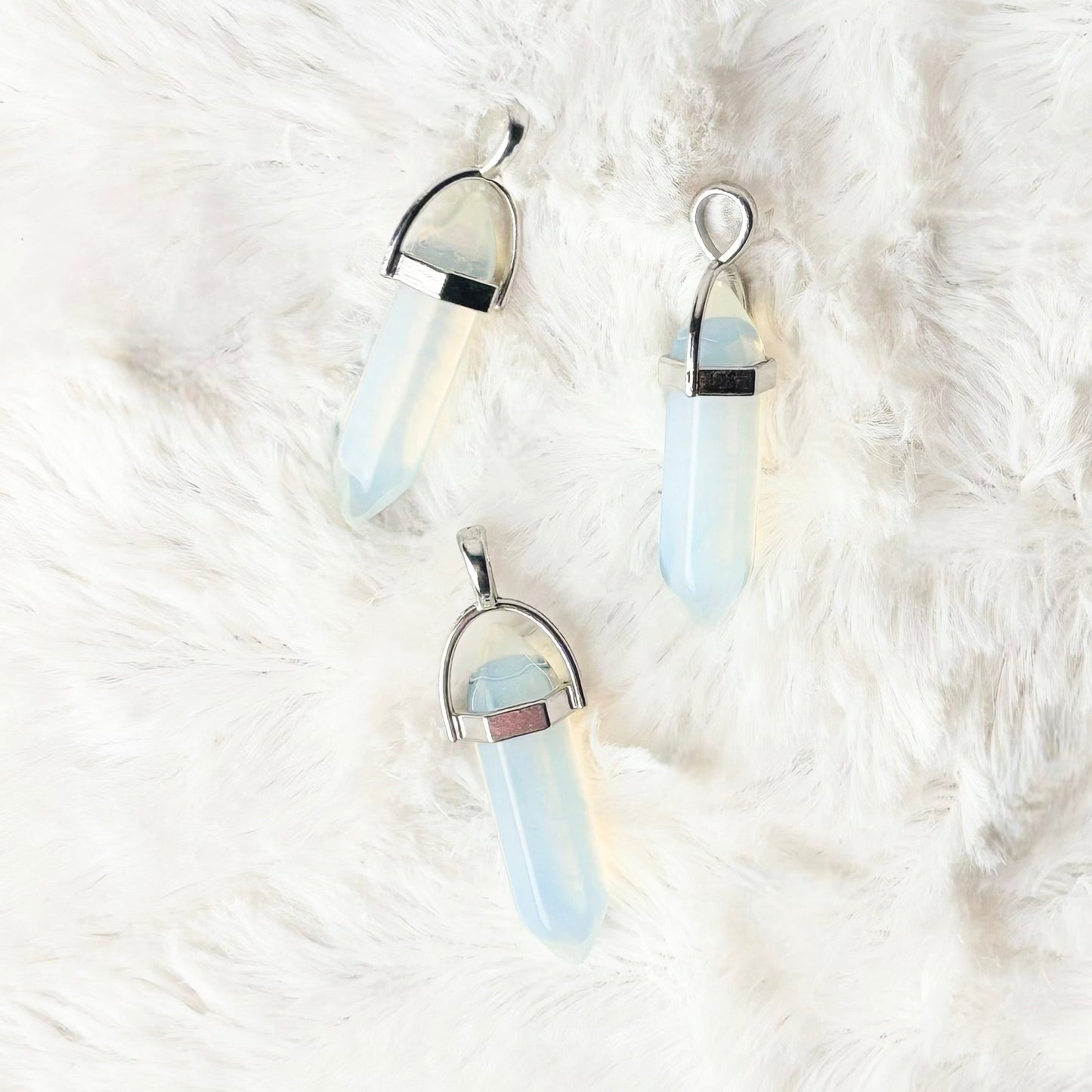 Pair of earrings on a white fur surface
