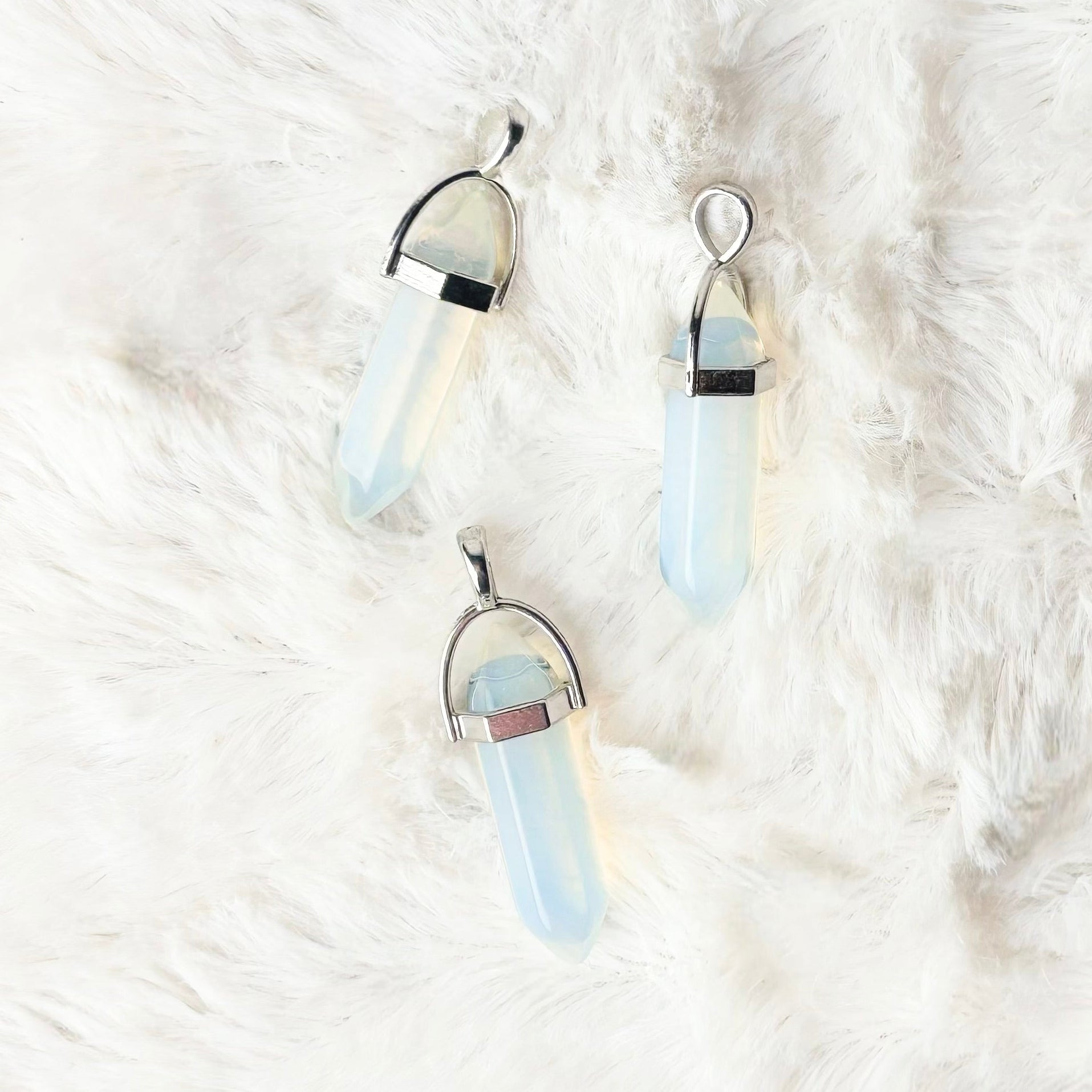 Pair of earrings on a white fur surface