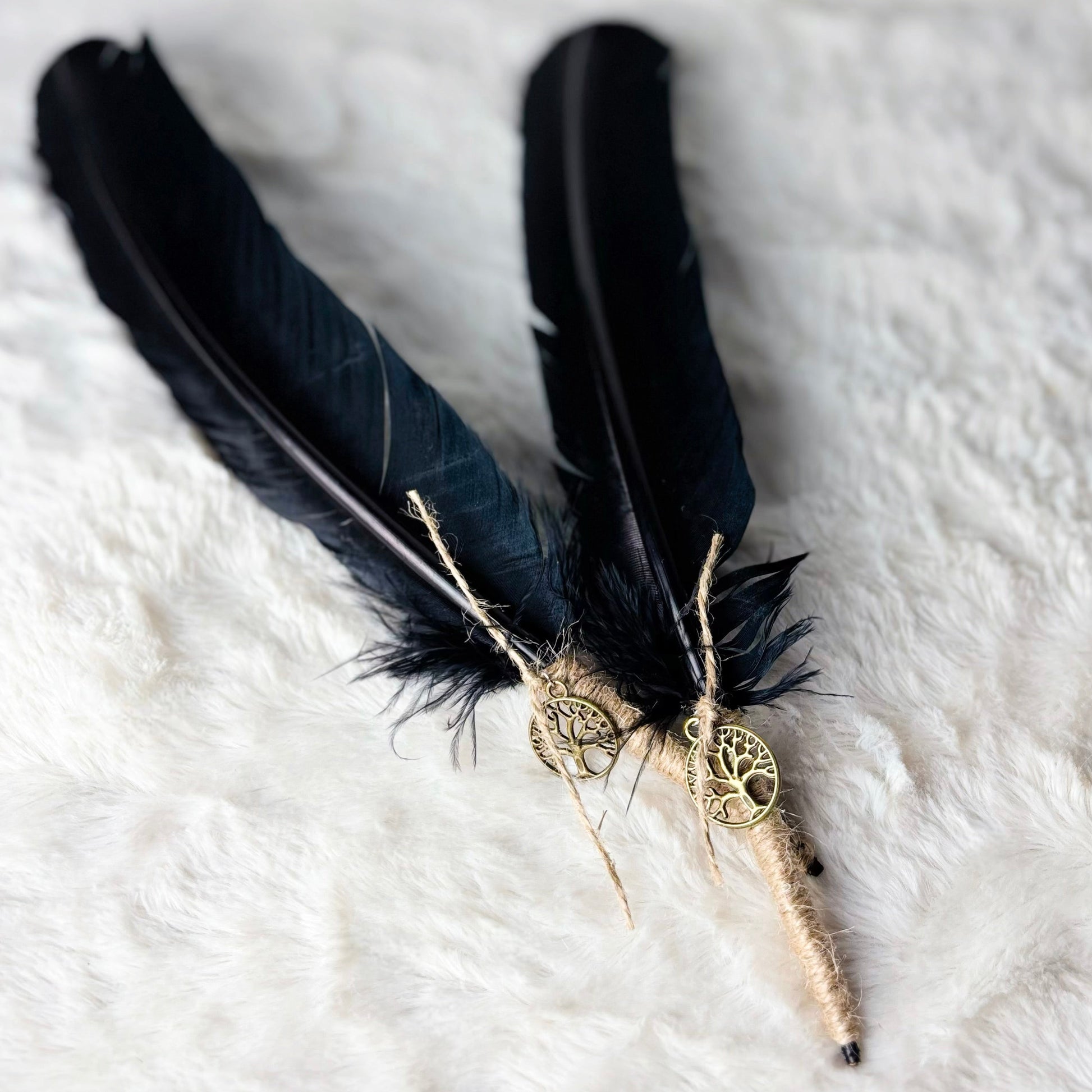 Black feathered hair accessory with decorative elements on a white textured background