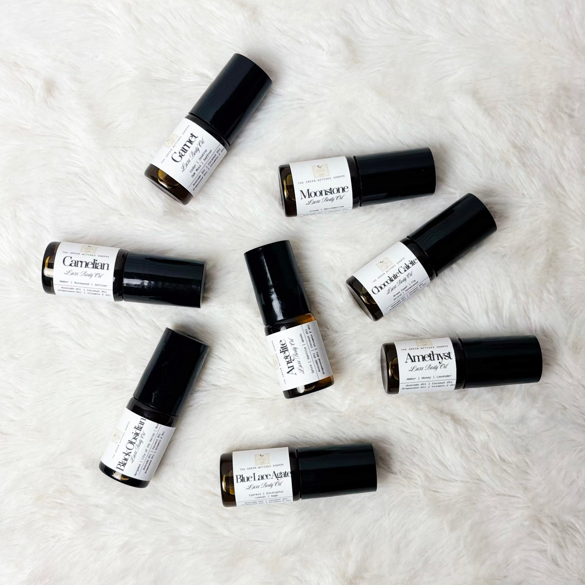 Set of small roller bottles on a textured white surface